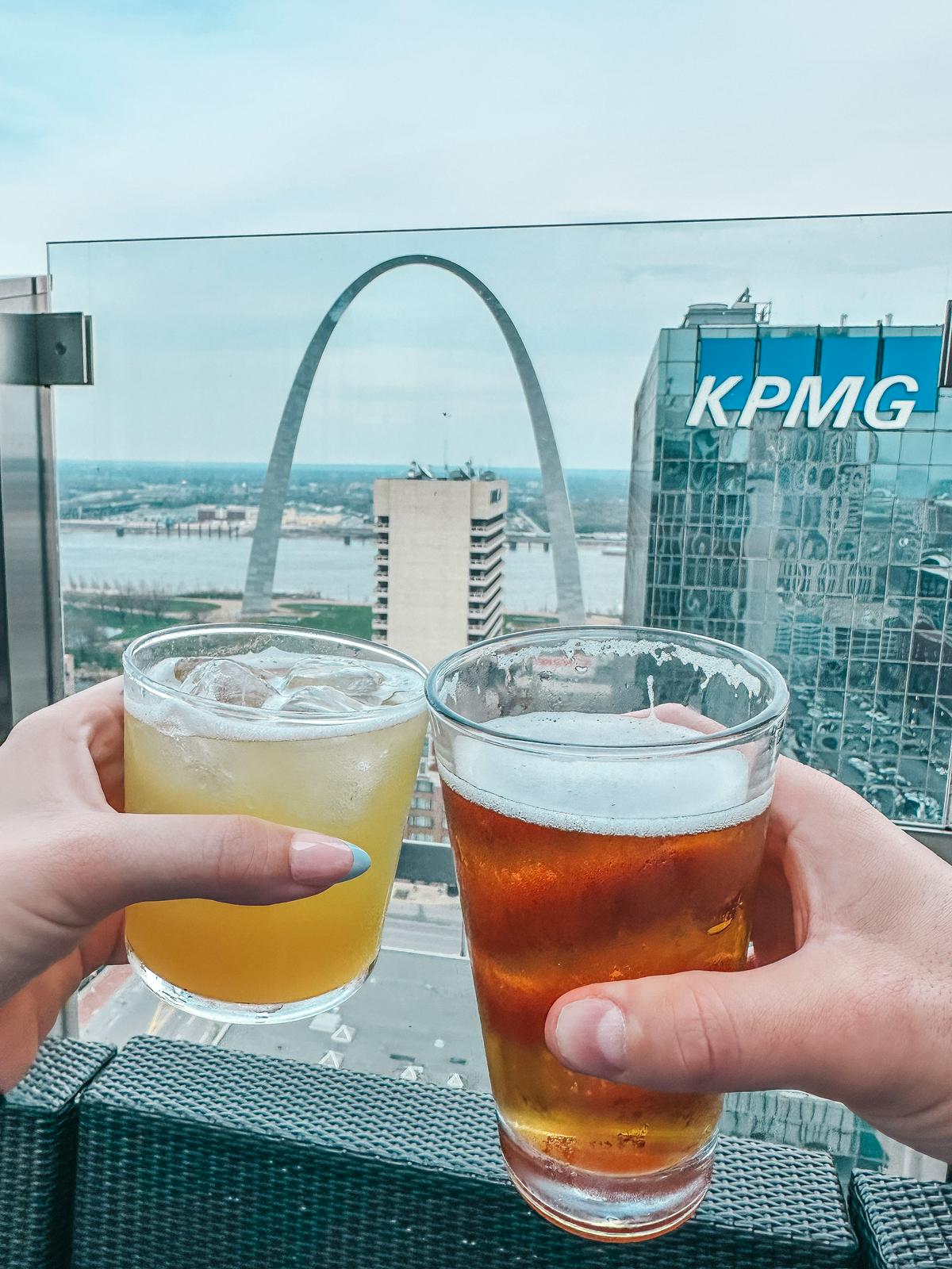 Cheersing drinks at 360 St Louis with the Gateway Arch in the background