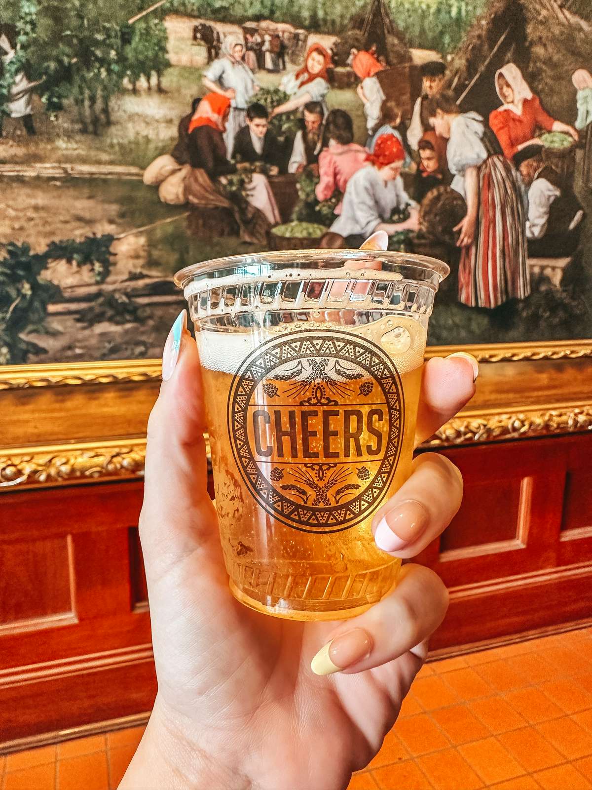 person holding a glass of beer in Anheuser-Busch Brewery as they spend the Weekend in St. Louis