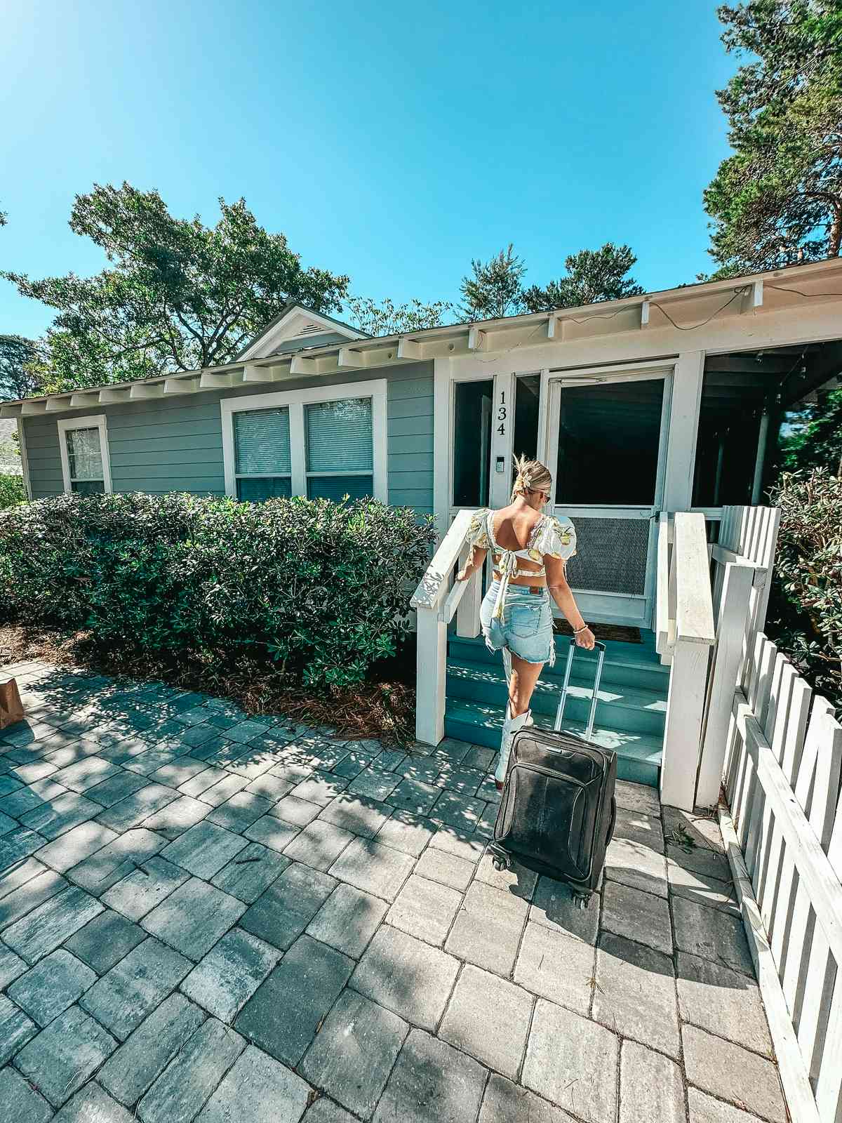 woman entering a beach bungalow one of the things to do in 30A