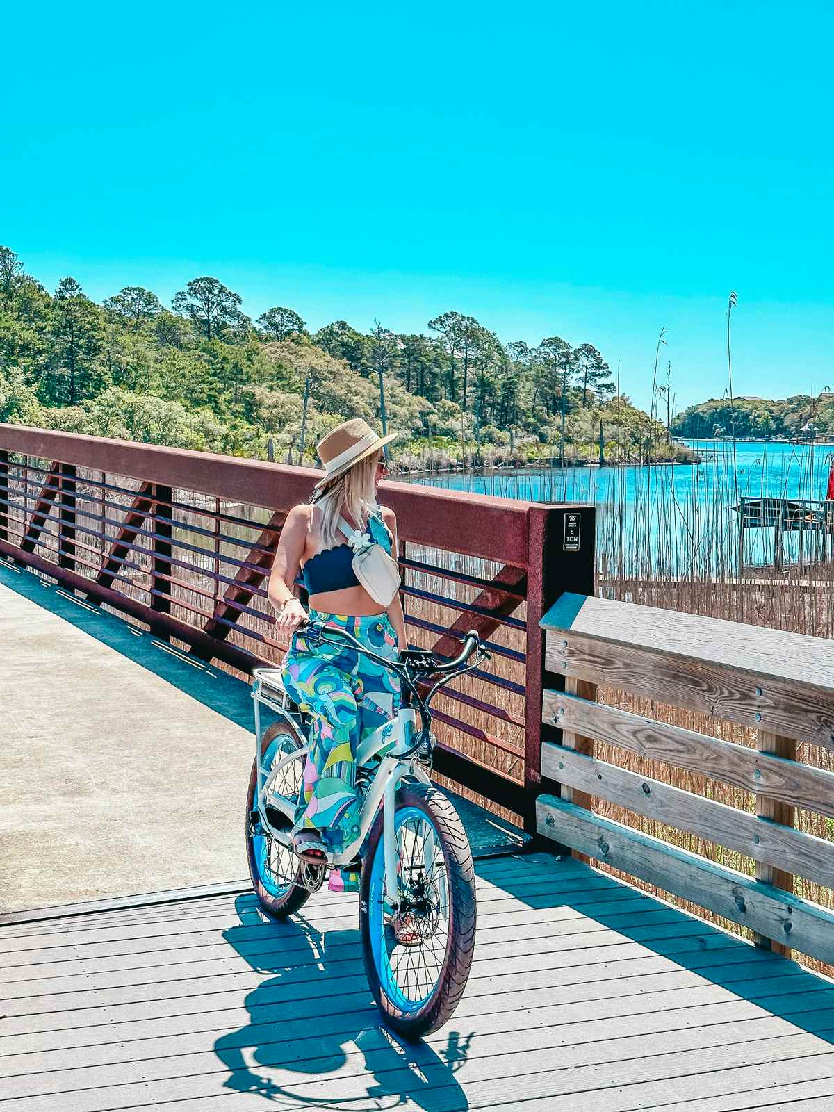 woman in tube top and colorful pants biking one of the things to do in 30A