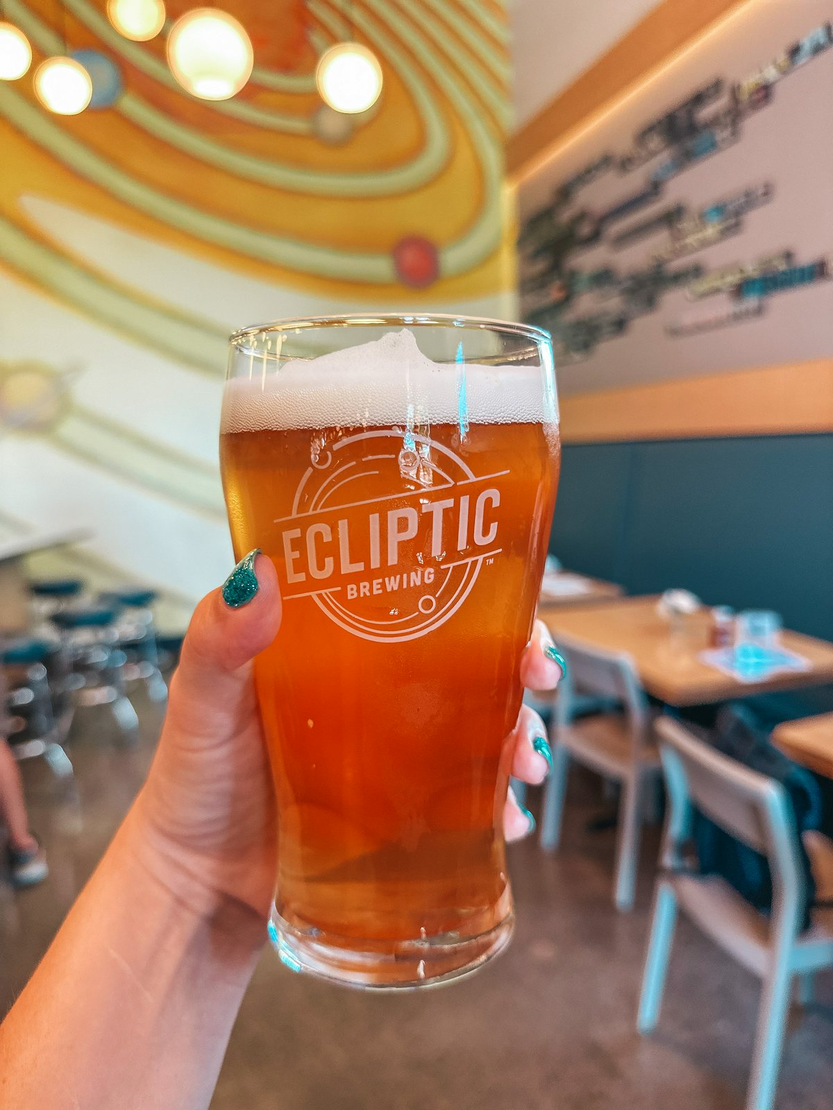 person spending the weekend in Portland and holding a beer from Ecliptic Brewing 