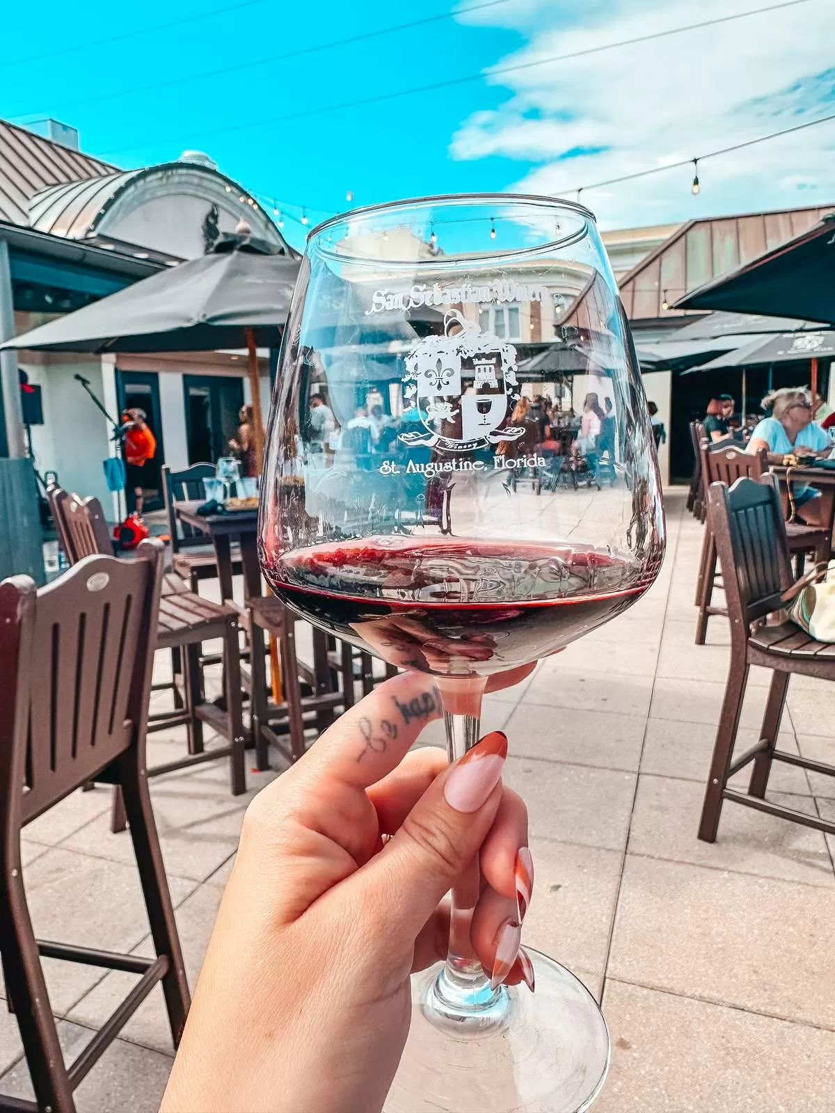 person holding a glass of wine