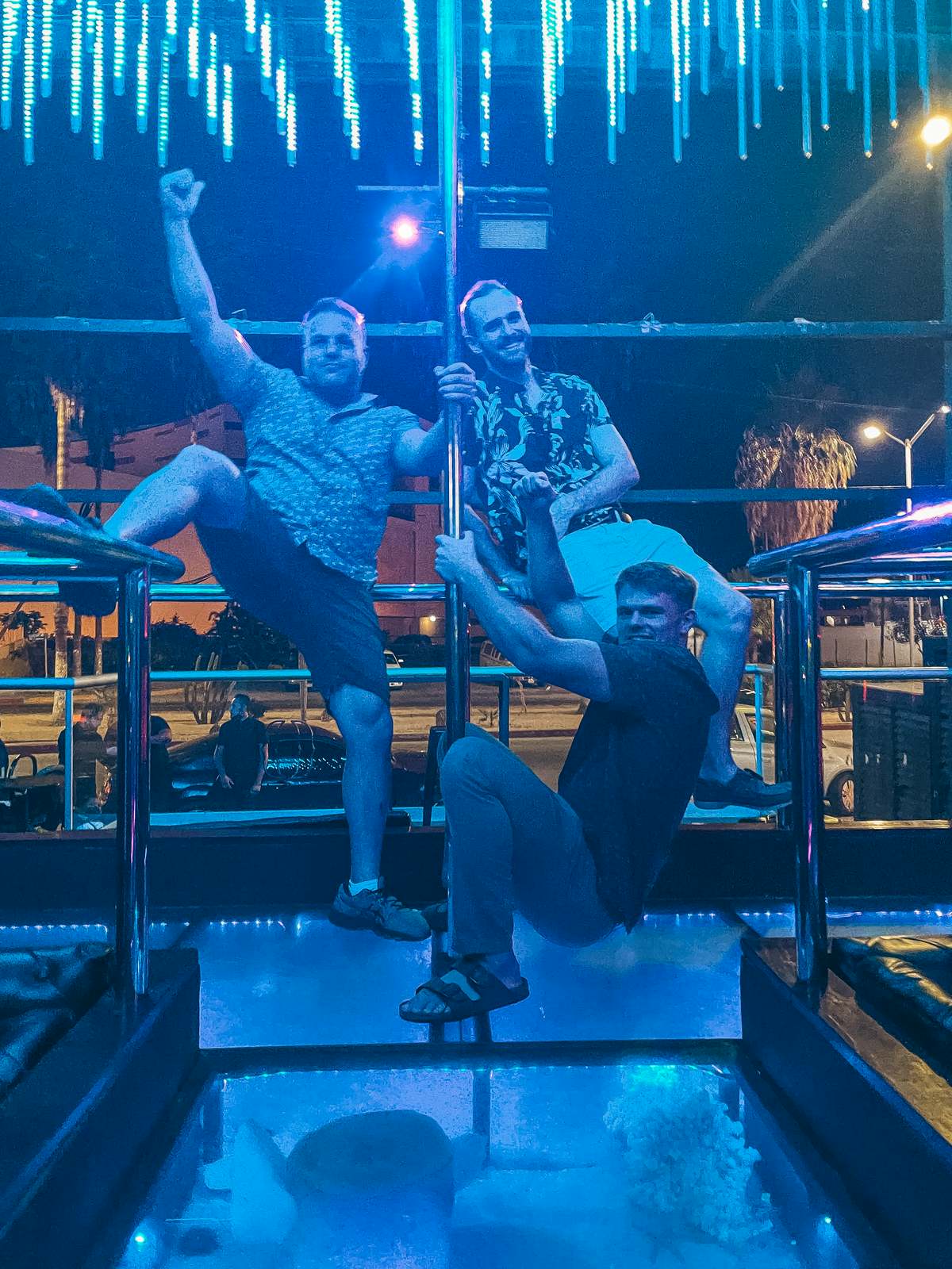 three men in a pole enjoying Cabo in December