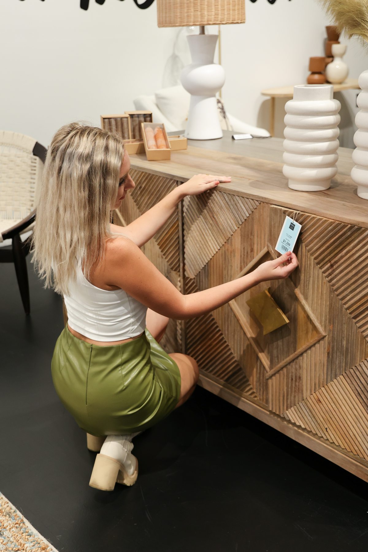 woman looking at a dresser at dwell home market