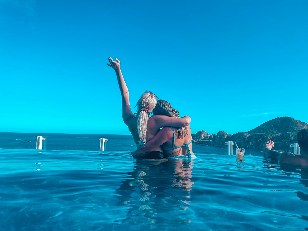 two women swimming in a pool in Cabo in December