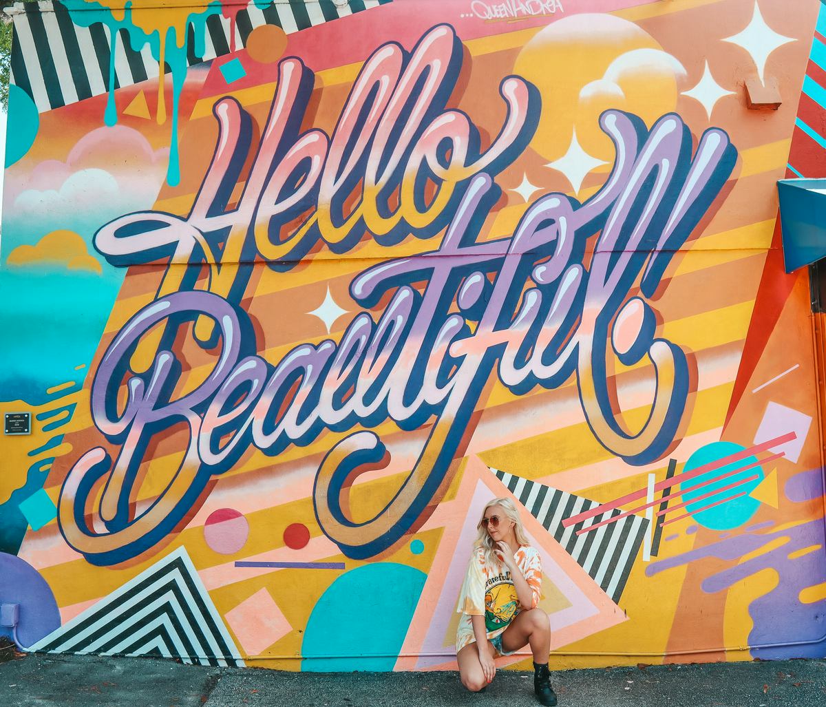 Destiny Snyder posing near a mural for a weekend getaways from Tampa