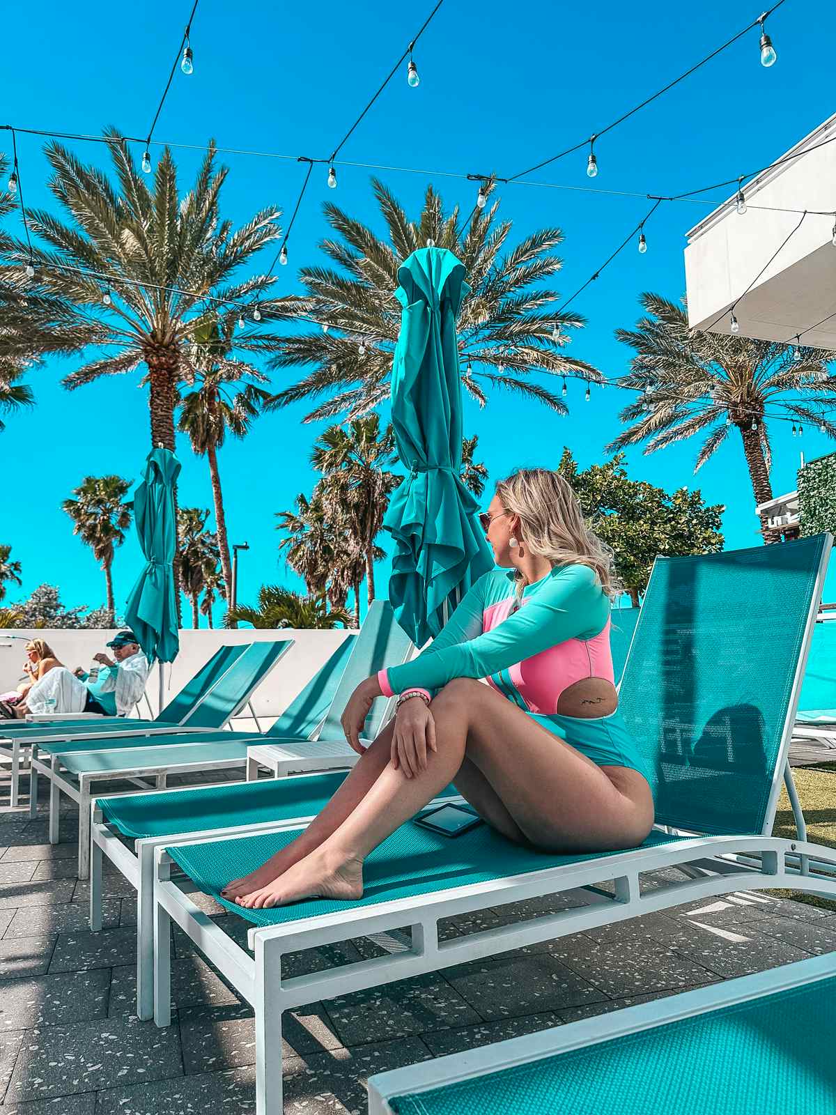 Woman lounging at the Wyndham Grand Clearwater Beach pool