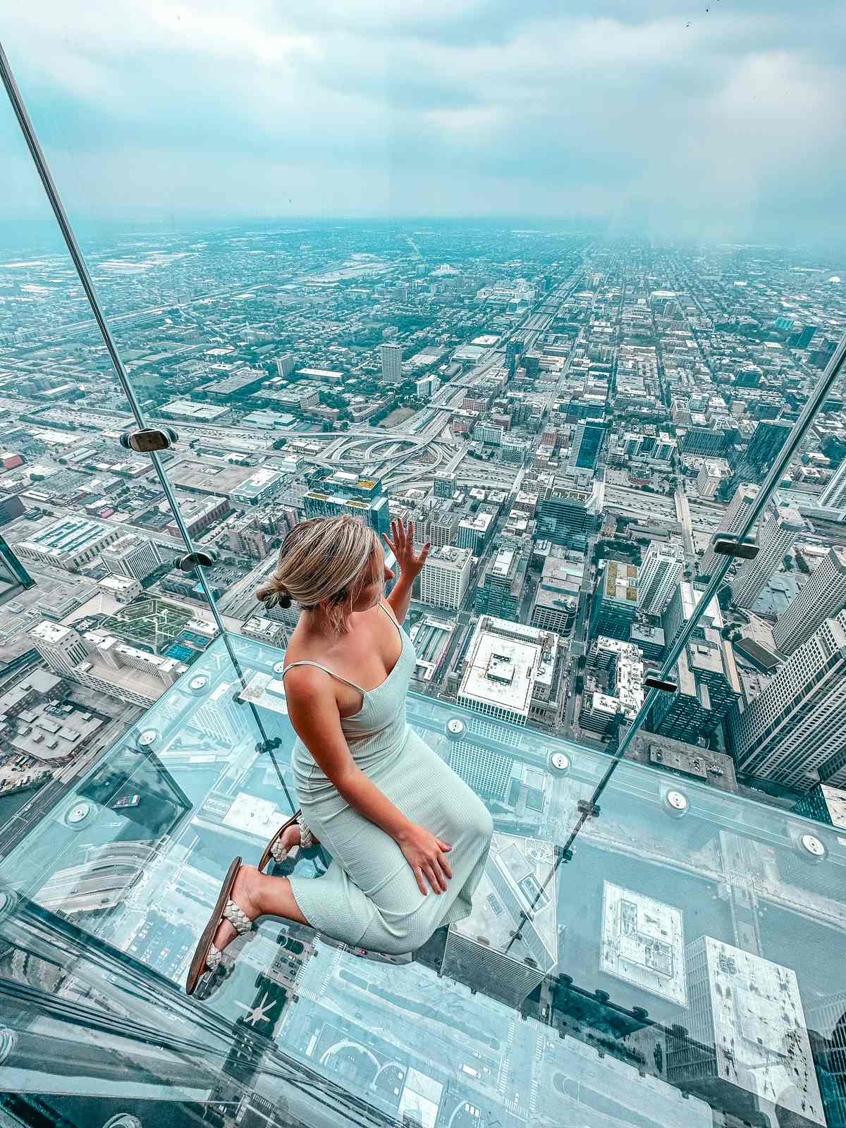 Sitting on glass platform at Skydeck Chicago