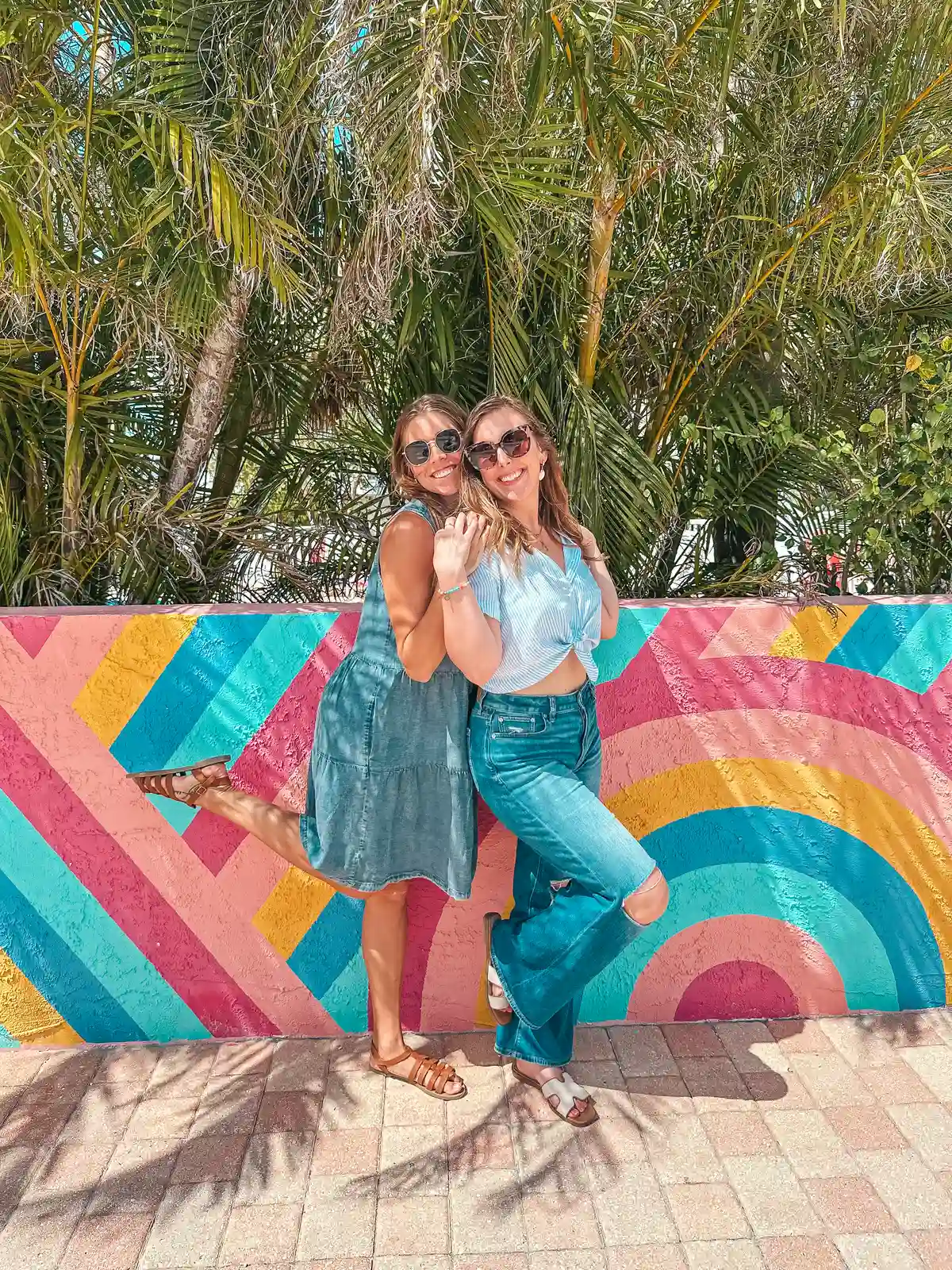 Friends enjoying colorful mural in Anna Maria Island