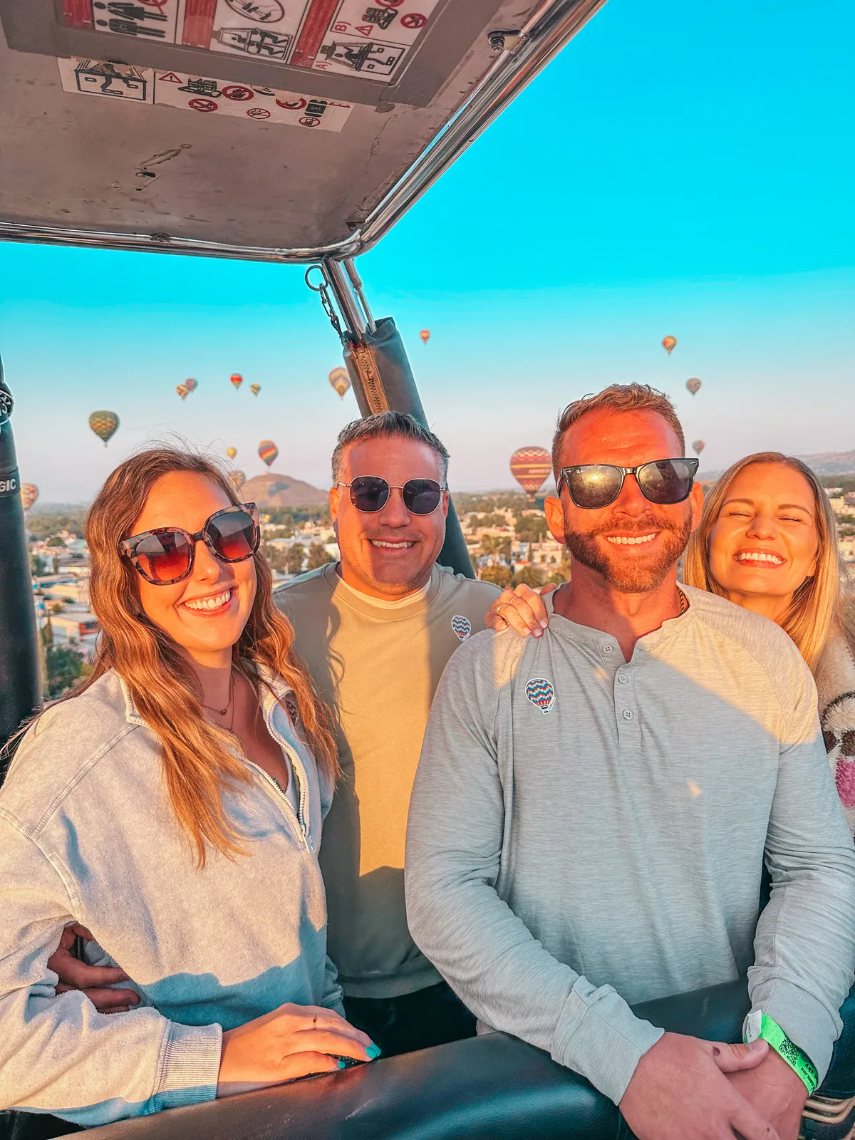 Friends enjoying hot air balloon ride over the Teotihuacan Pyramids