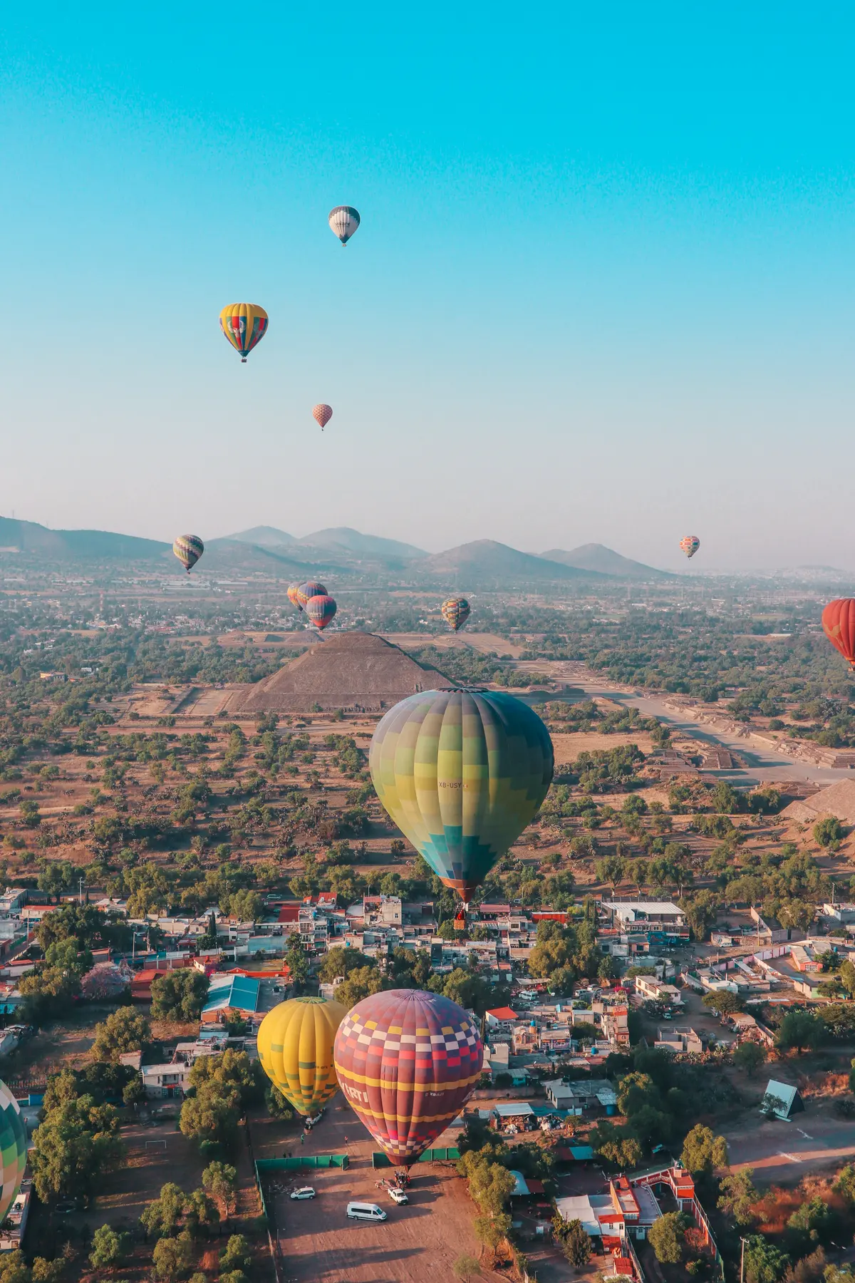 Hot air balloons landing near the Teotihuacan pyramids