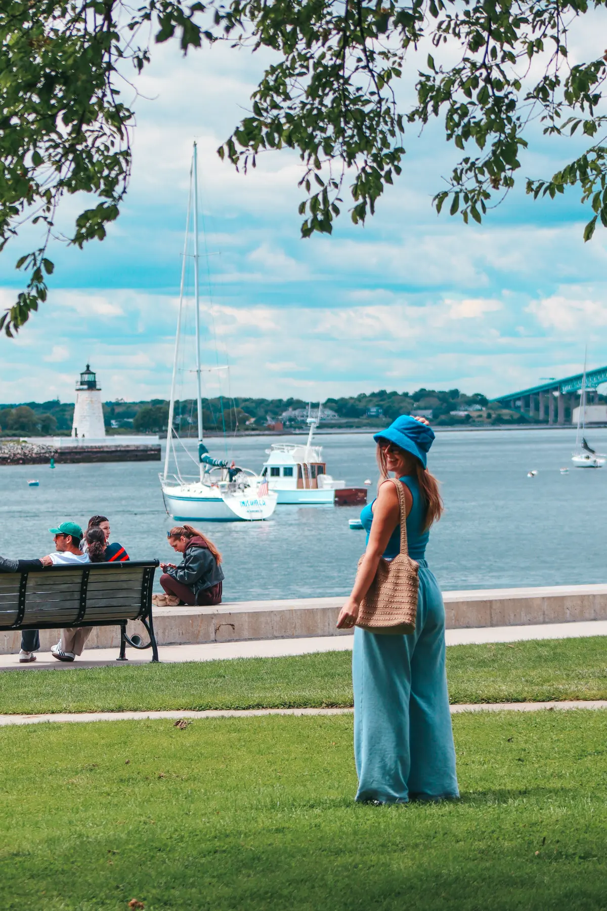 Destiny posing with Newport Harbor Light and boats in the background
