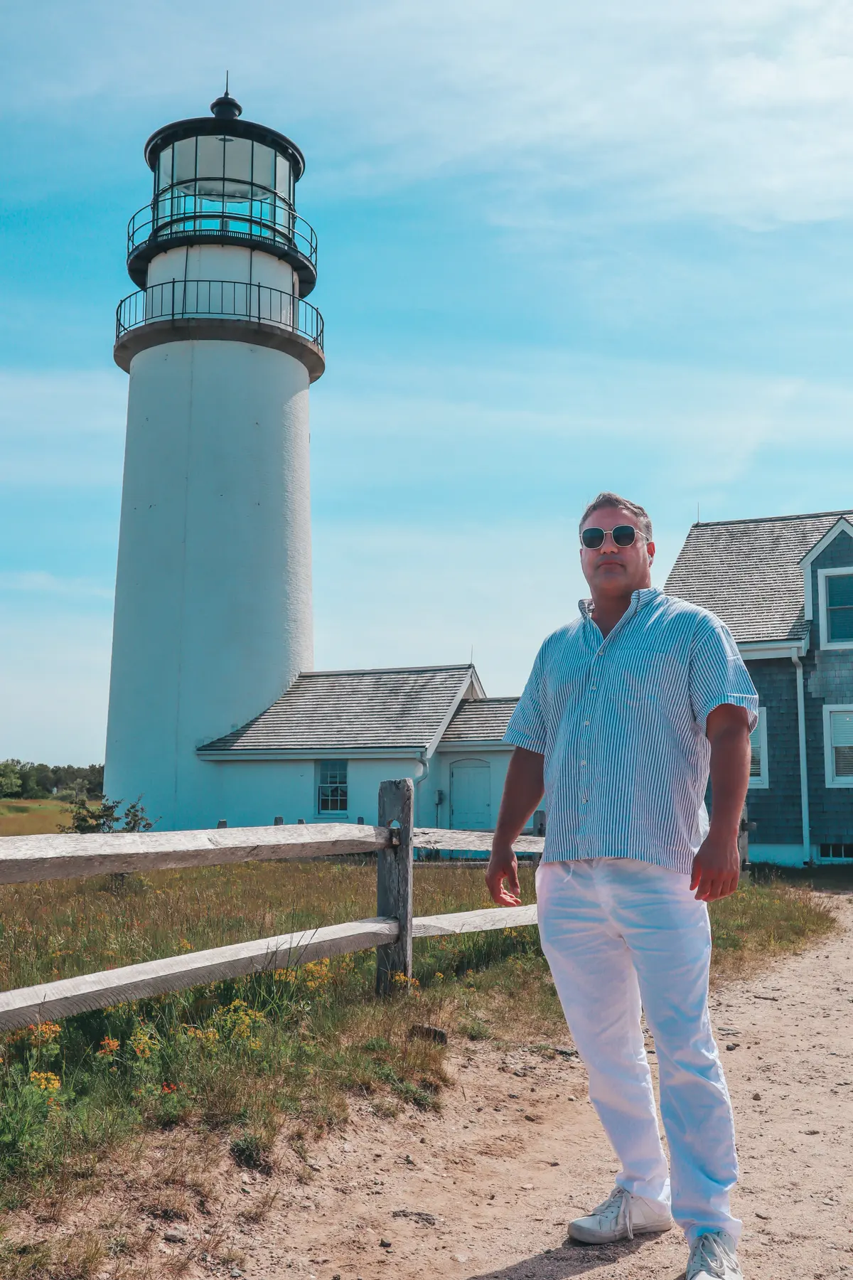 Man standing with Highland Light behind him