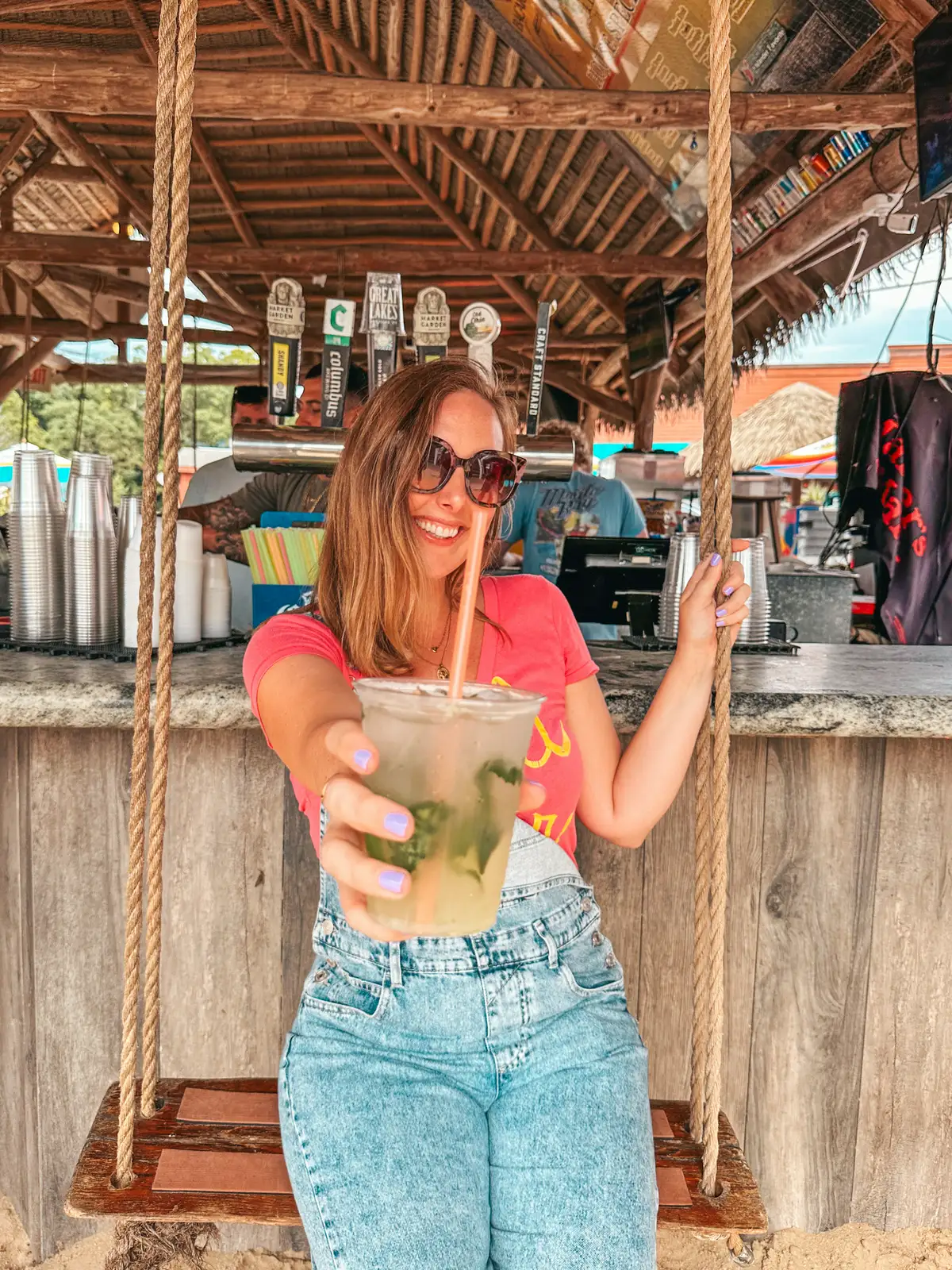 Woman enjoying a mojito from Mojito Bay on Put in Bay