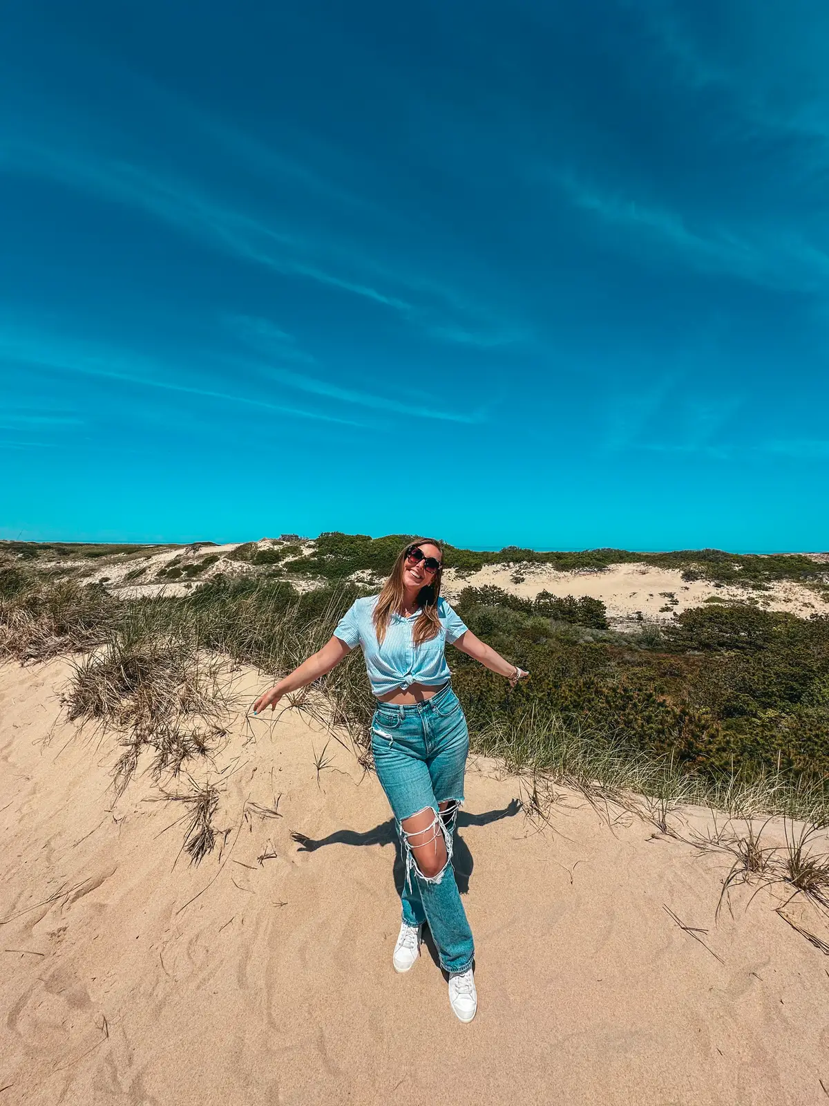 Woman posing at the Cape Cod National Seashore sand dunes