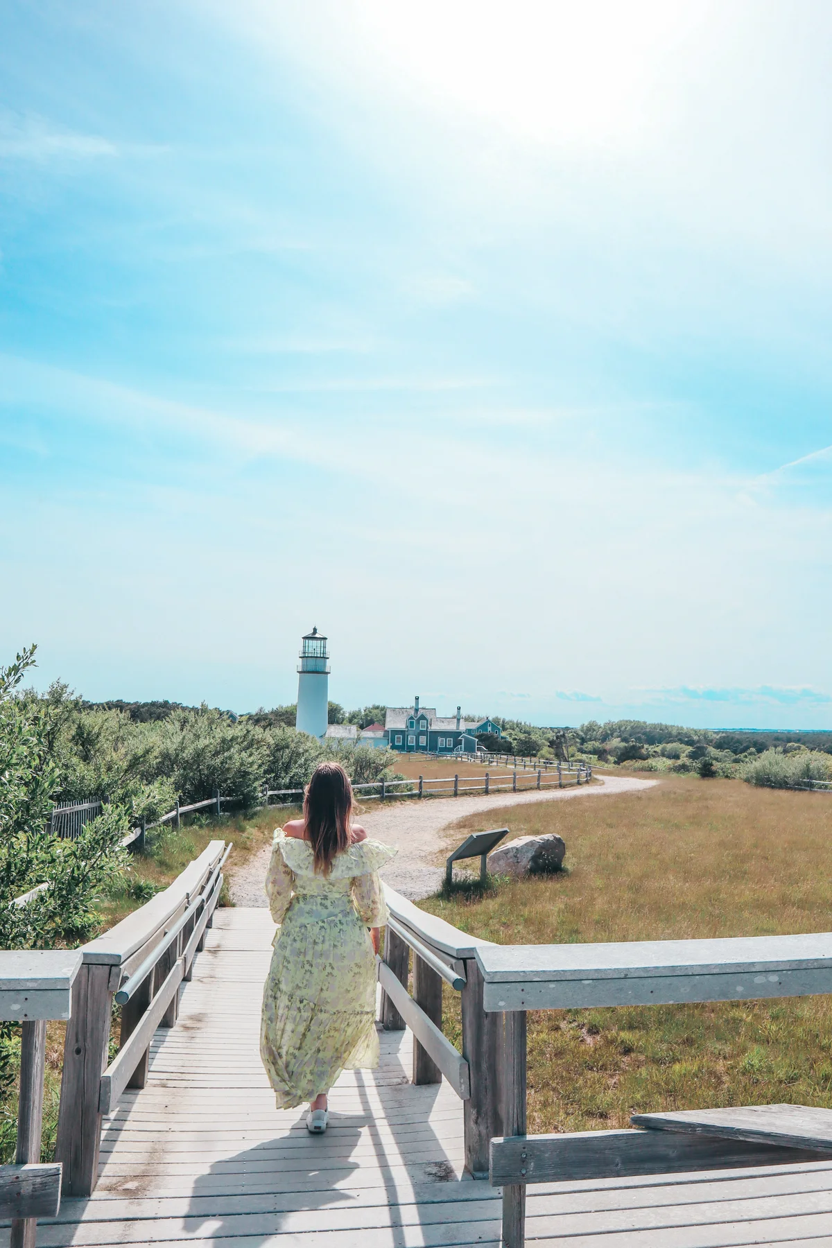 Woman walking towards Highland Light on Cape Cod