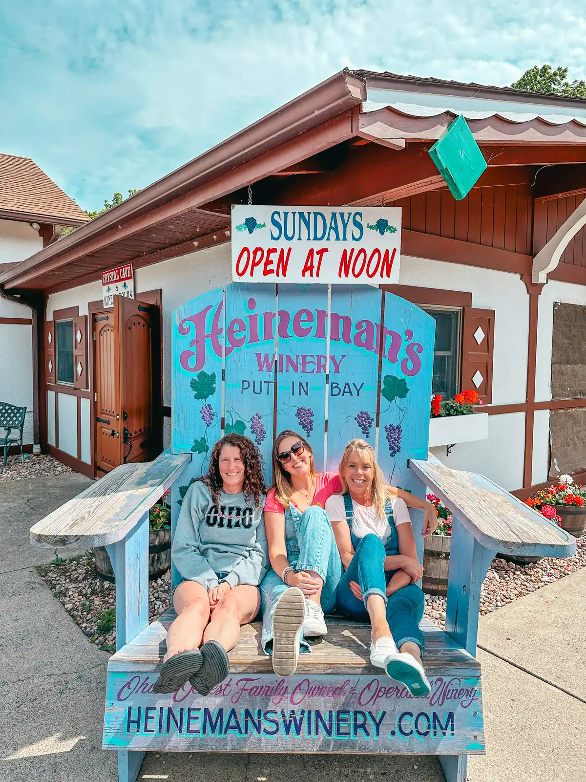 Women sitting on a chair outside of Heinemans Winery on Put in Bay