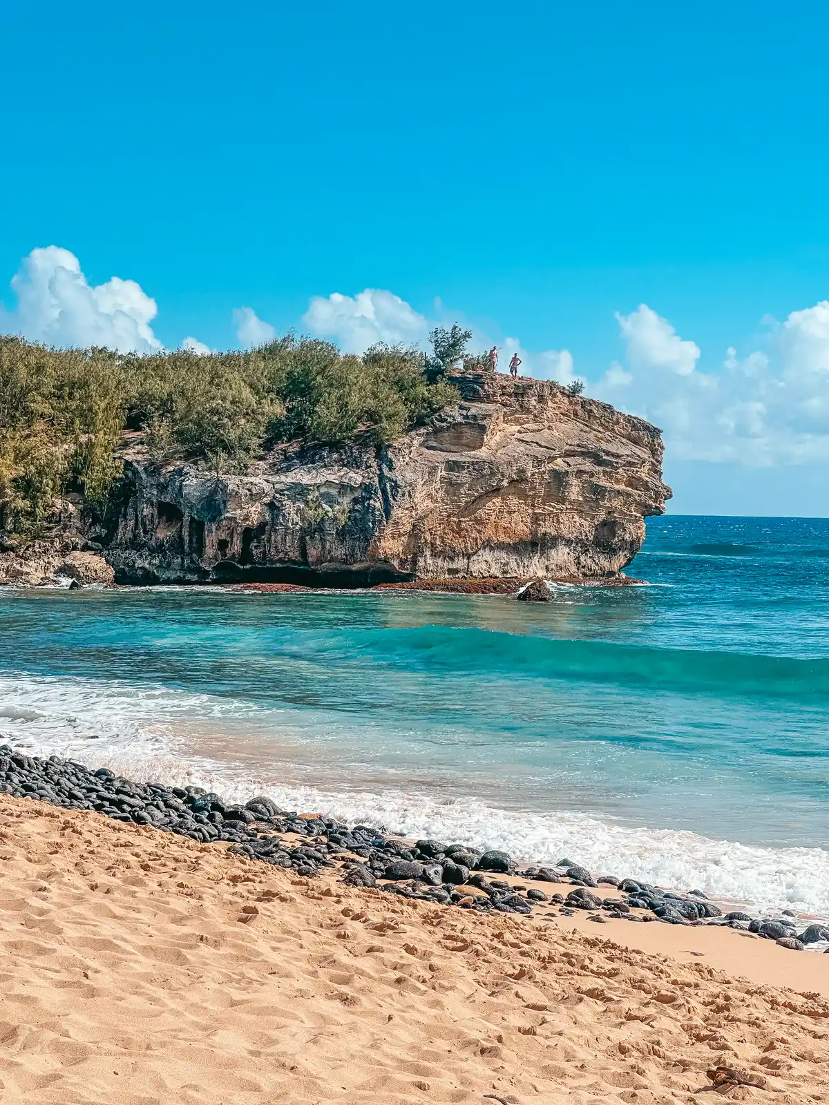Cliff jumping at Shipwreck Beach on Kauai
