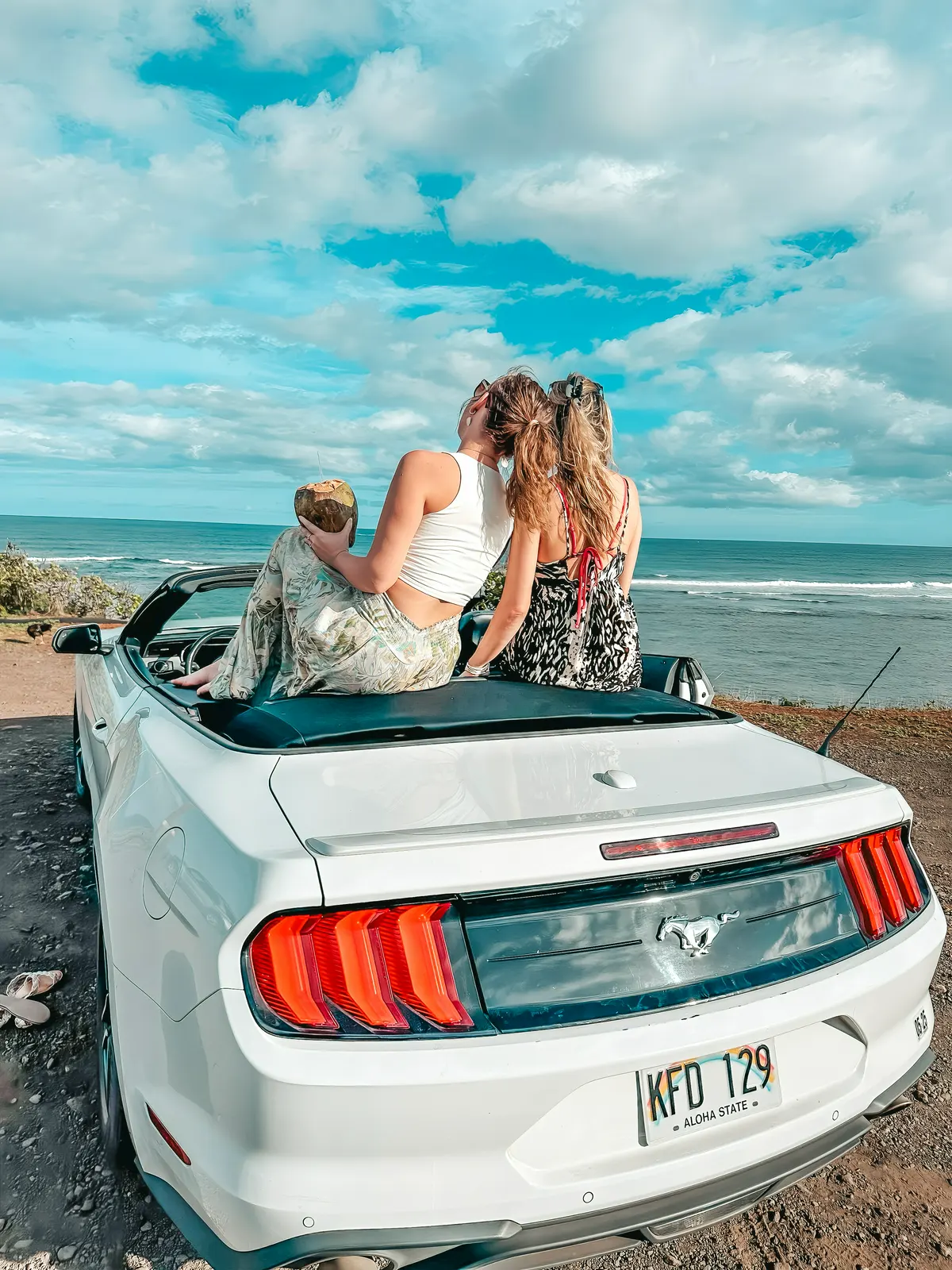 Friends sitting in the back of convertible on Kauai Hawaii