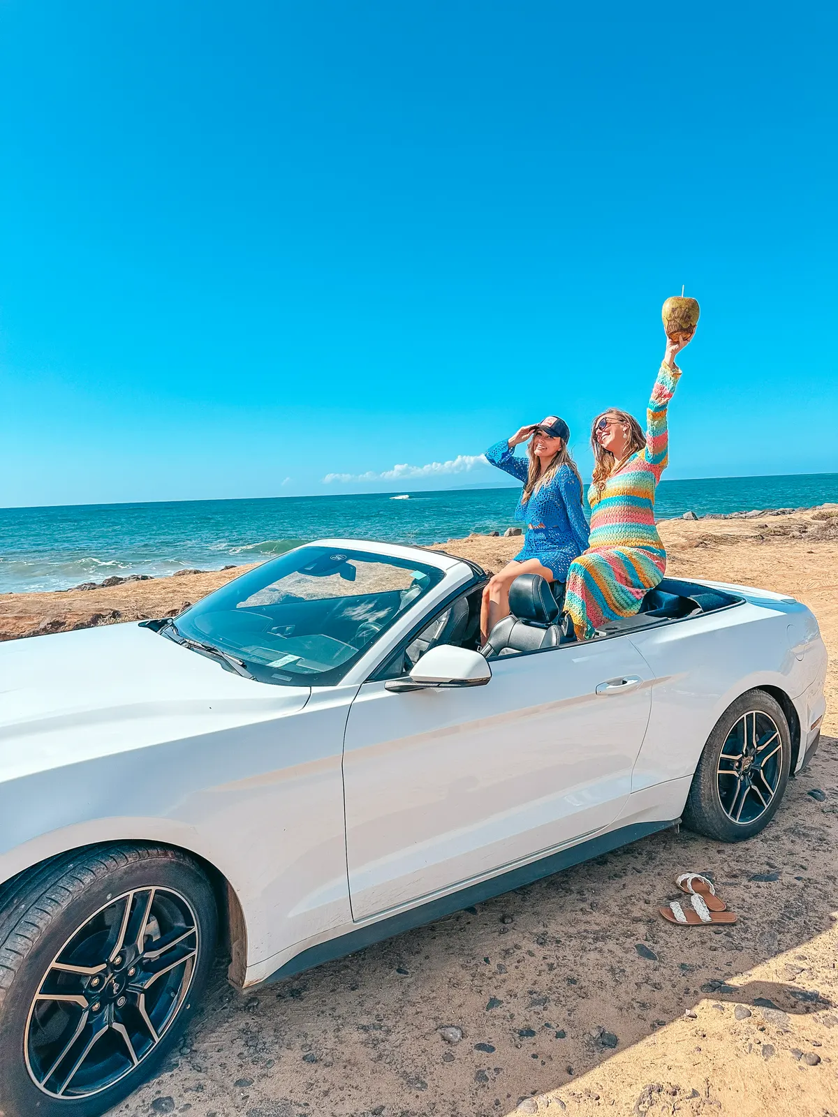 Friends sitting in the back of convertible on Kauai