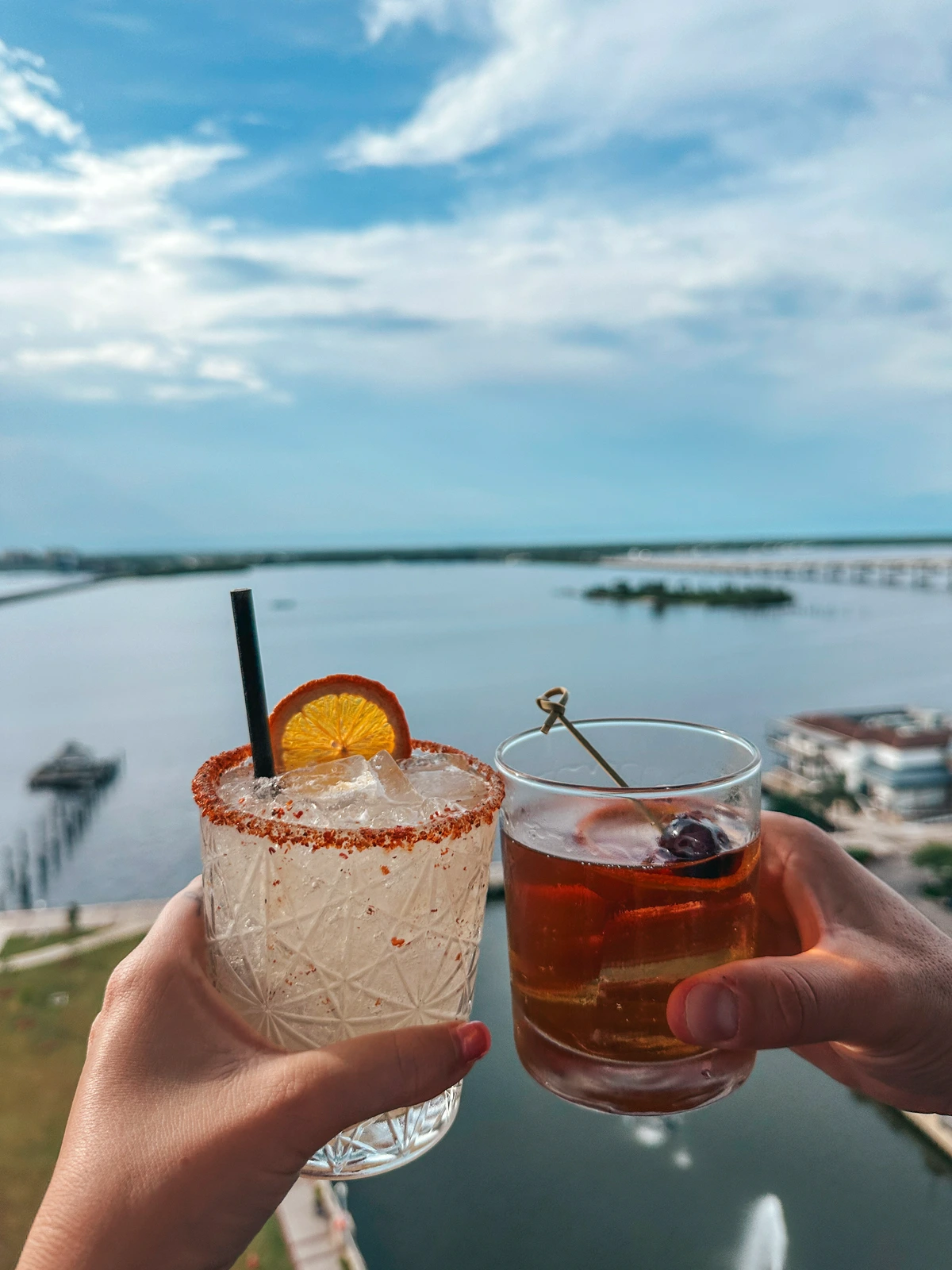 Cheersing cocktails at Beacon Social Drinkery rooftop bar in Fort Myers