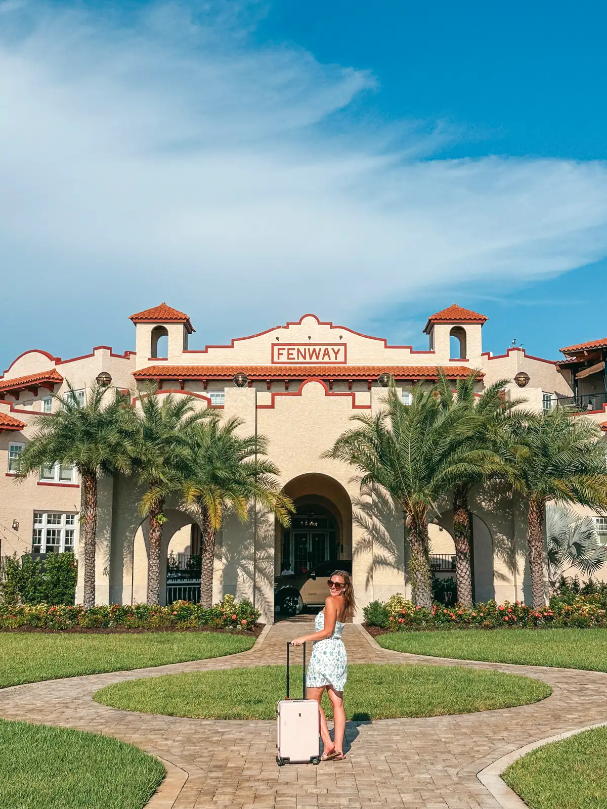 Woman standing in front of Fenway Hotel in Dunedin Florida