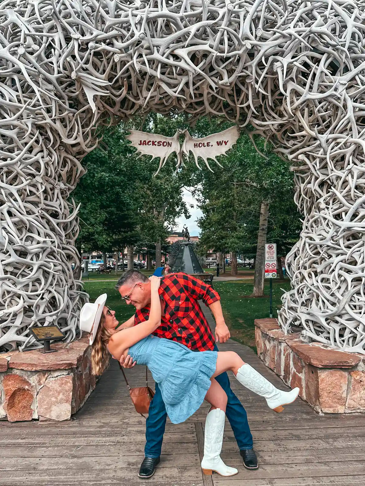 Man Dipping A Woman In Front Of The Antler Arches In Jackson Hole Wyoming