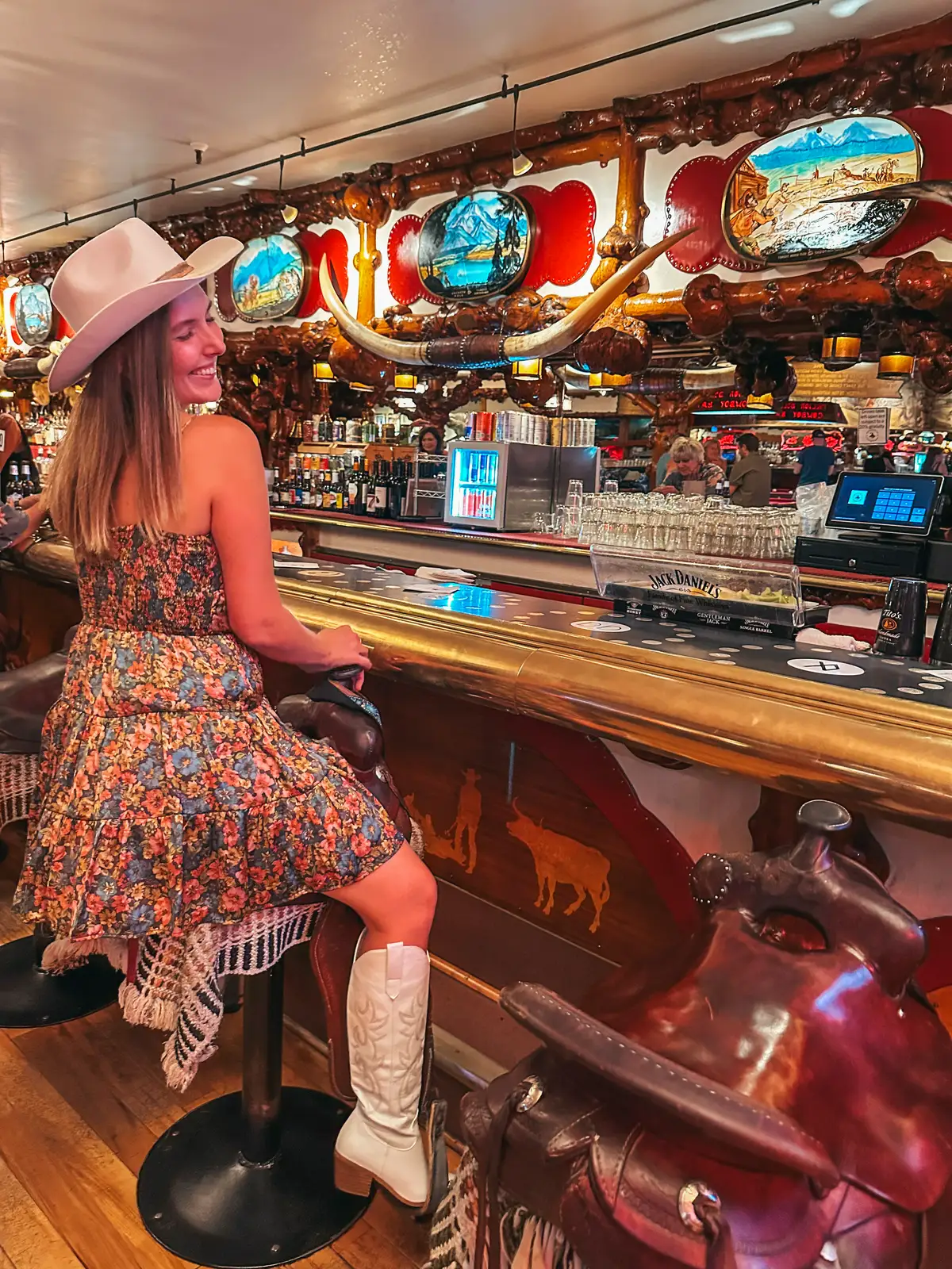 Woman Sitting On Saddle Seat At Million Dollar Cowboy Bar In Jackson Wyoming