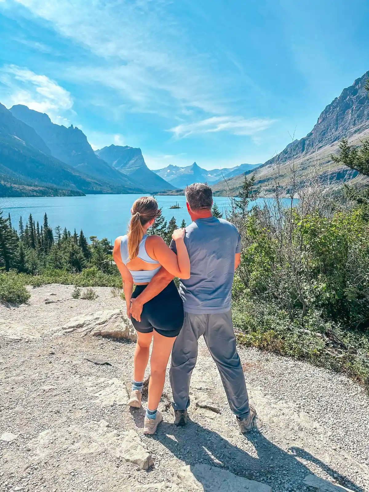 Couple At Wild Goose Island Lookout In Glacier National Park