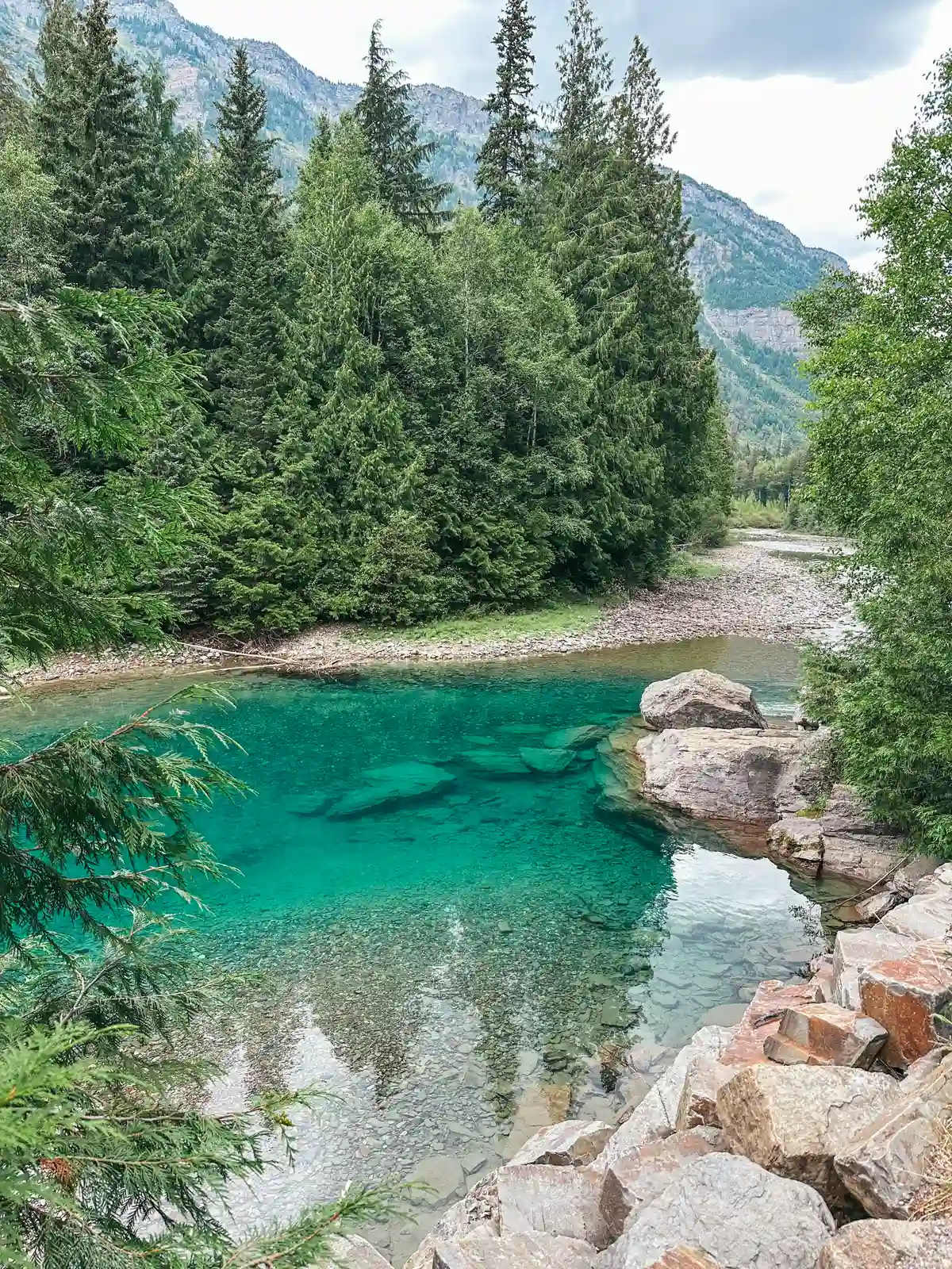 Turquoise Water At Red Rock Area In Glacier National Park