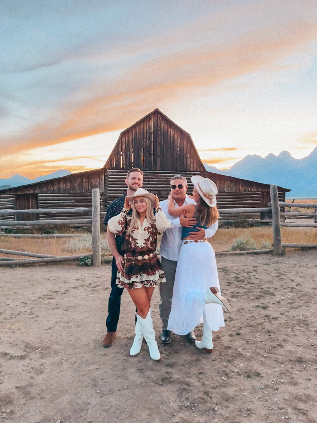Two Couples Posing In Front Of Mormon Row In Grand Teton National Park