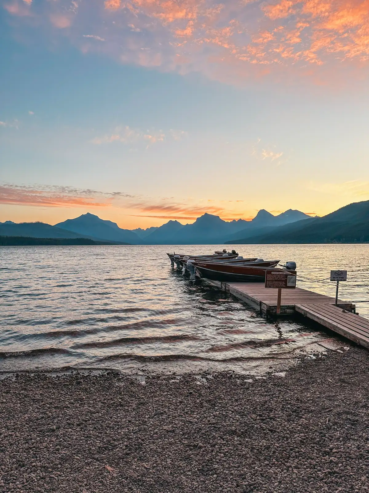 View Of Boats Docked At Sunrise On Lake McDonald In Glacier National Park