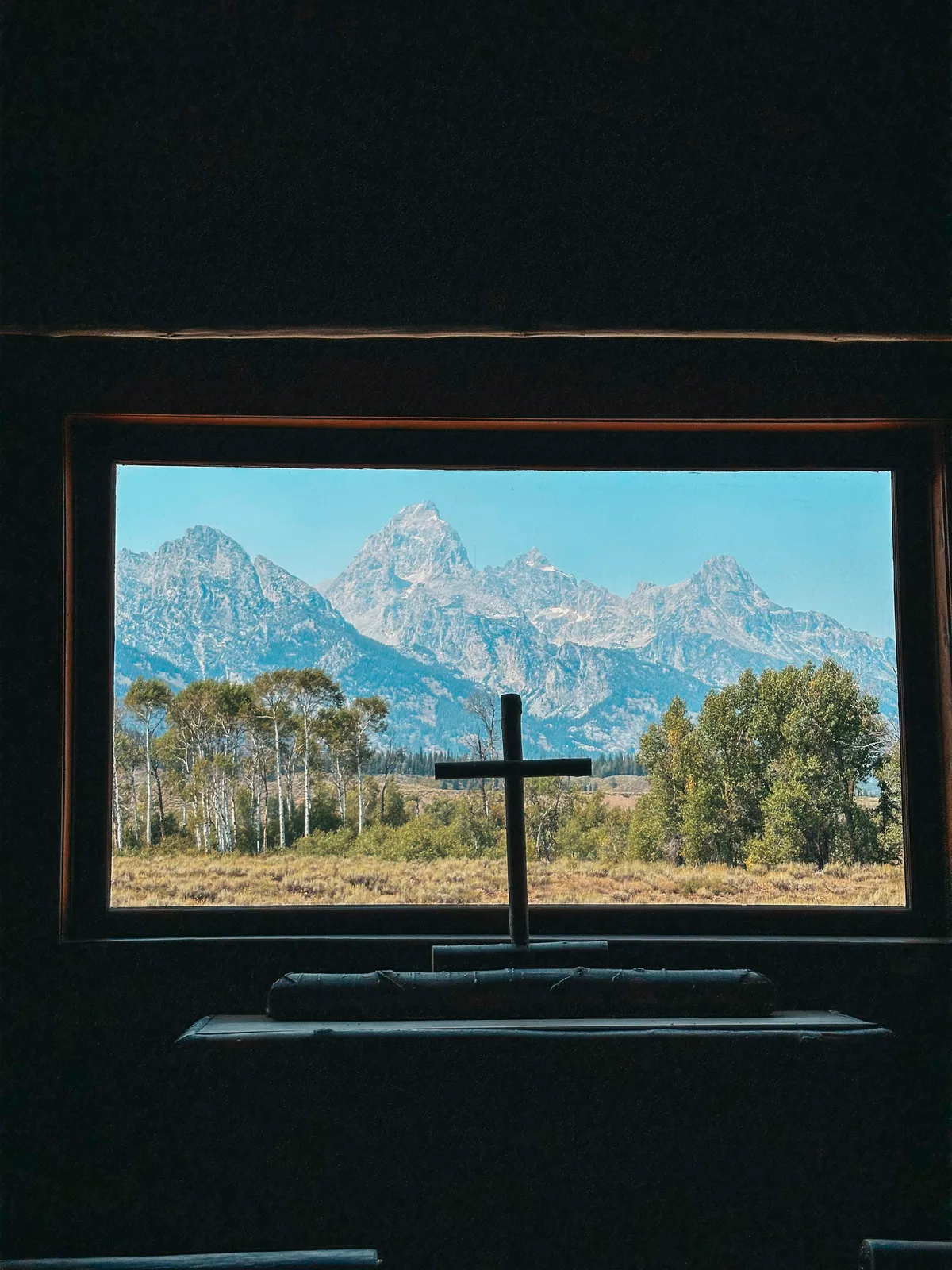 Views Inside Of The Church Of The Transfiguration With Cross And Mountain Range In The Background At Grand Teton National Park