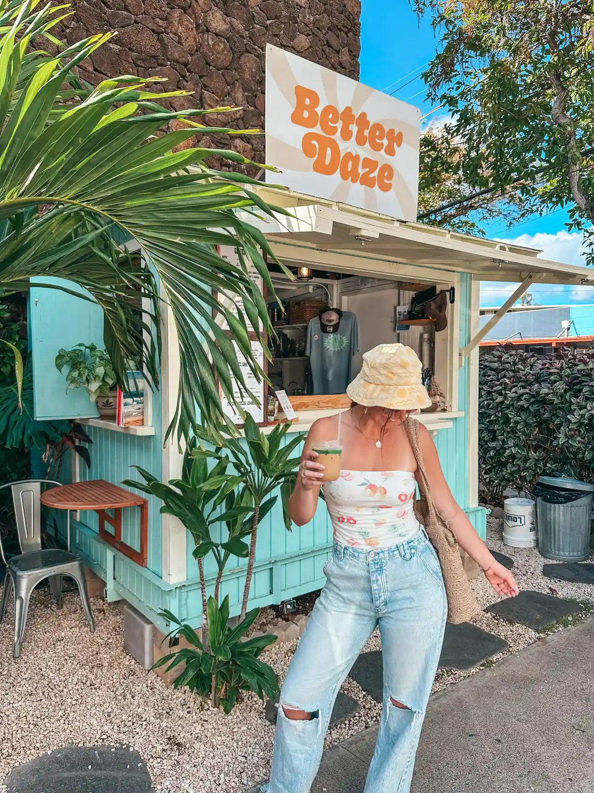 Woman Posing With Iced Latte In Front Of Better Daze Coffee In Honolulu