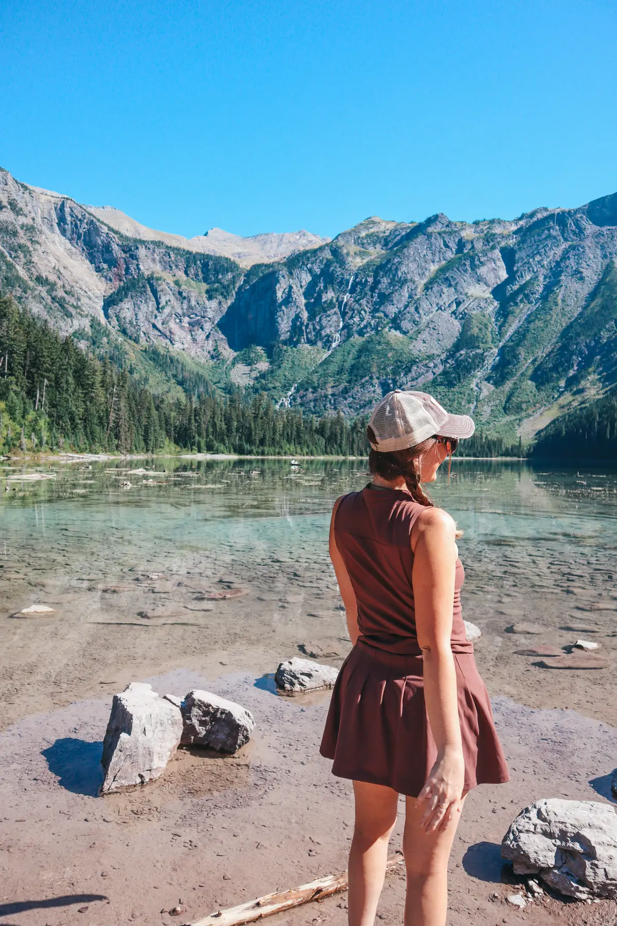 Woman Standing At Avalanche Lake In Glacier National Park
