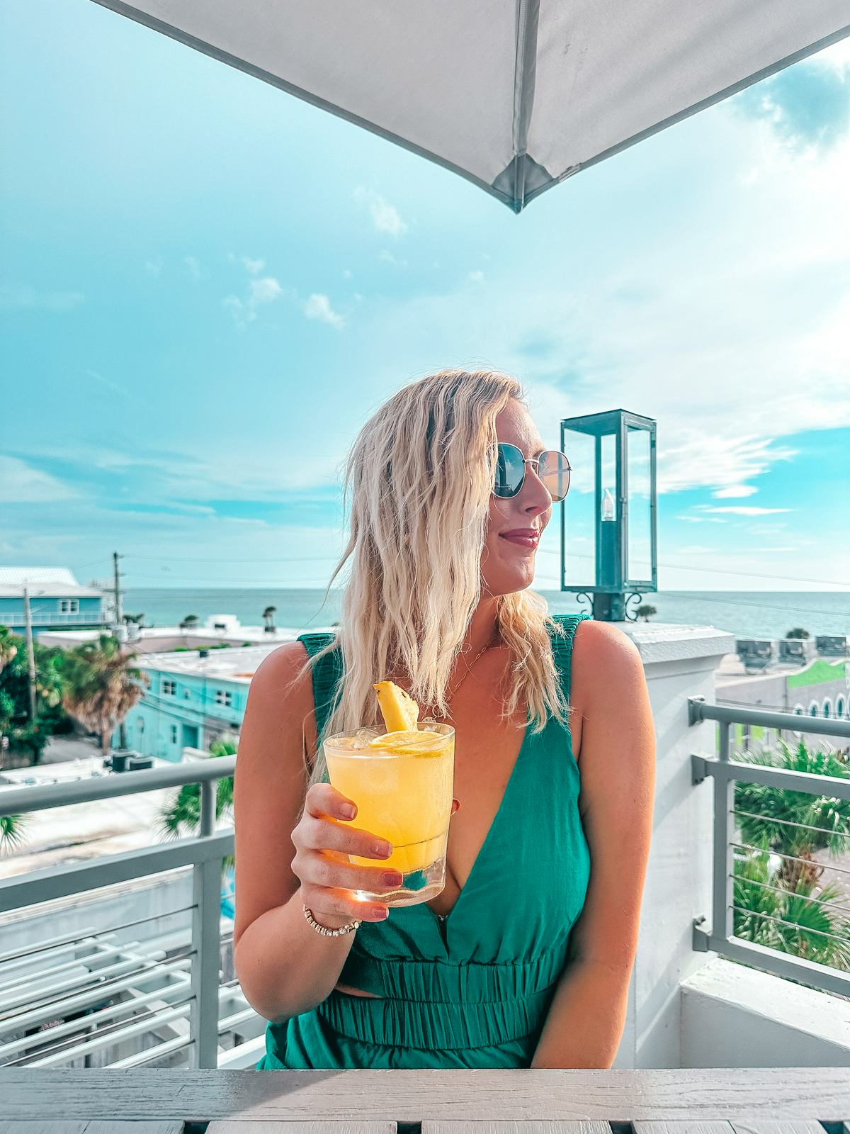 Enjoying A Cocktail At Berkley Beach Club Rooftop Bar In Pass A Grille