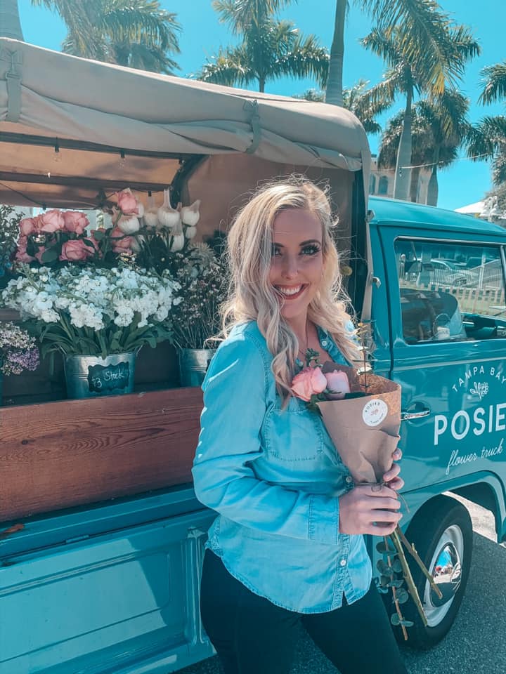 Woman Holding Bouquet In Front Of Posies Flower Truck In Tampa Bay