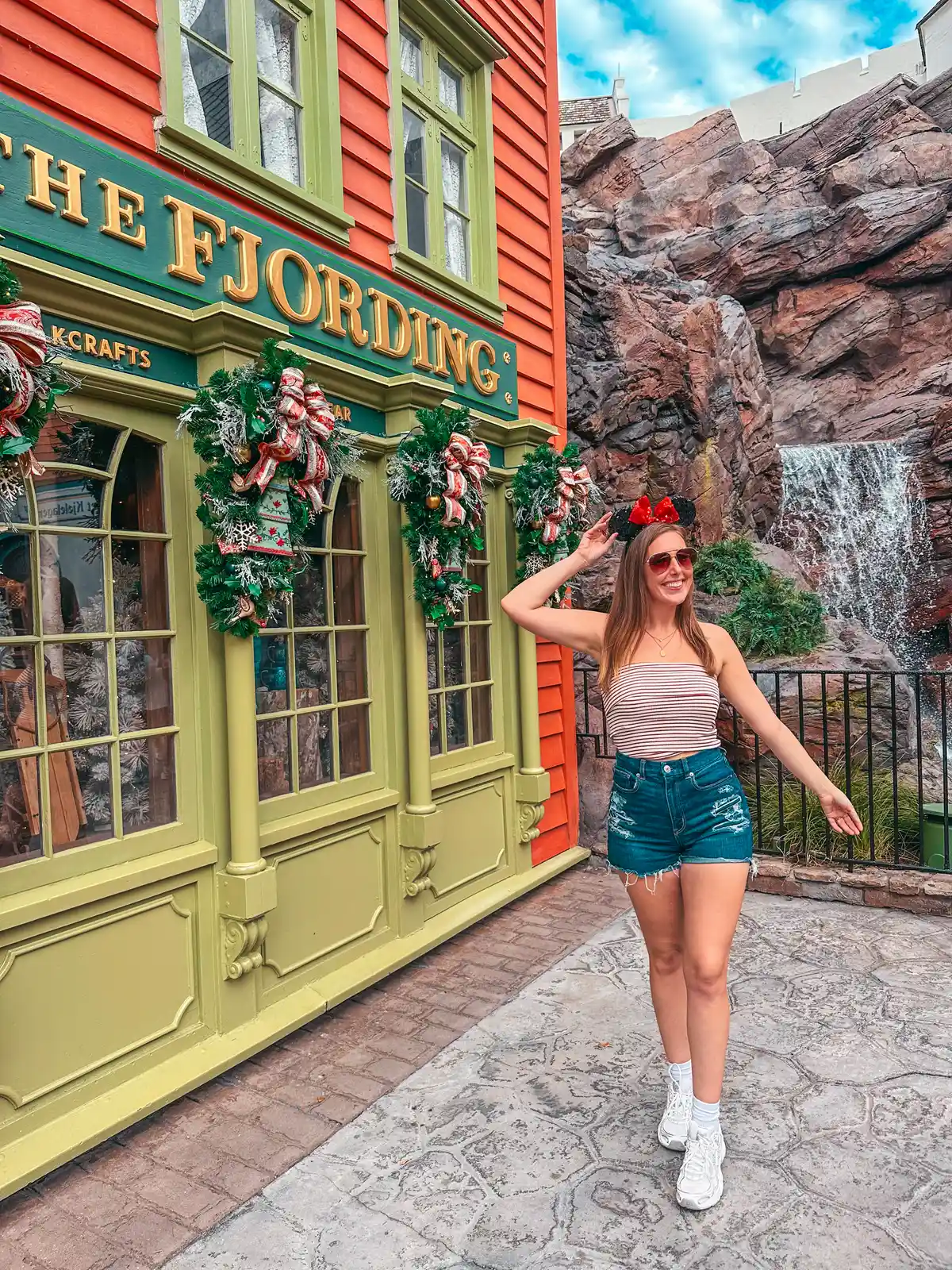 Woman Wearing Minnie Ears Posing In Front Of The Fjording In Norway At Epcot